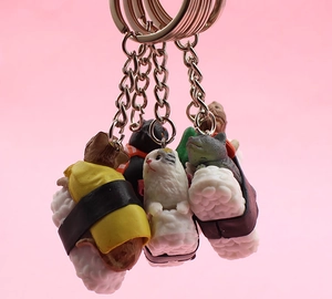 Detail of creative Neko Sushi cat keychains featuring cute kittens on rice with metal rings