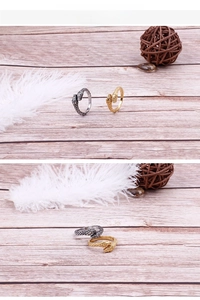 Detail of gold and silver snake rings with textured scales and cobra head carving