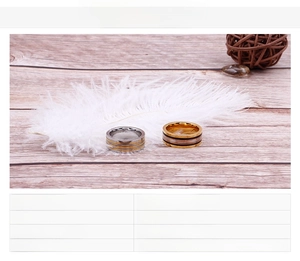 Detailed view of two-tone gold and silver striped stainless steel rings for couples
