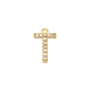 Close-up of golden letter T pendant with micro-pave cubic zirconia on white background