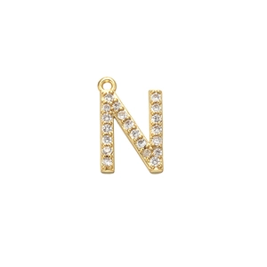 Macro detail of gold letter N pendant with micro-pave cubic zirconia and top ring
