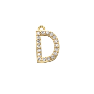 Macro detail of a gold letter D pendant with micro-paved sparkling cubic zirconia stones