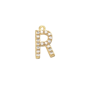 Detailed view of large gold letter R pendant with micro-pave cubic zirconia crystals