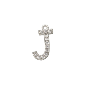 Macro detail of silver letter J pendant featuring micro-paved cubic zirconia crystals