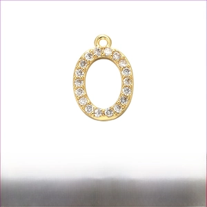 Detail of gold brass oval pendant with micro-paved cubic zirconia 12mm x 15mm