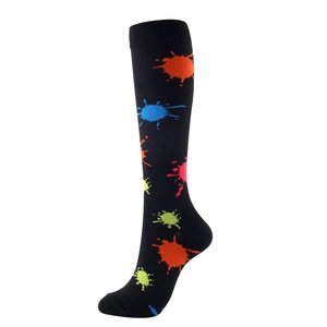 Compression socks with vibrant neon paint splash patterns on high knee black athletic fabric