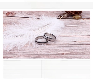 Detail of silver stainless steel rings with minimalist black groove and polished finish