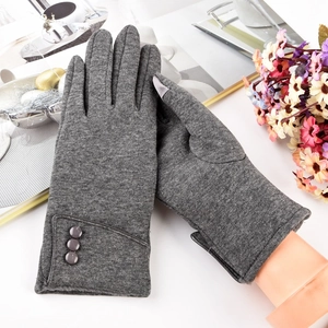 Detail view of gray winter gloves featuring plush lining and three decorative wrist buttons