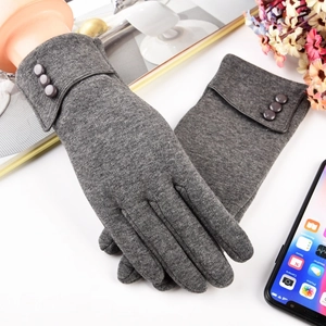 Close-up of gray thermal knit gloves with decorative buttons and ribbed cuff details