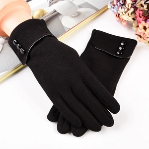 Detailed view of women's warm thermal gloves with decorative buttons and leather trim