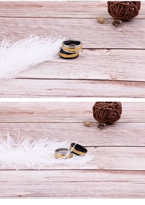 Close-up of black and gold two-tone brushed titanium steel ring with stripe groove design
