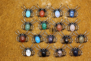 Macro view of spiders jewelry set with various natural gemstones in vintage silver setting