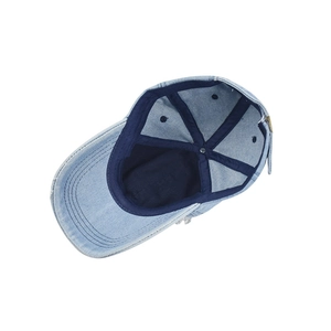Detailed interior of a light blue denim baseball cap showing reinforced seams and lining