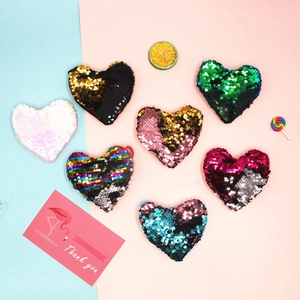 Colorful heart-shaped reversible sequin coin purses for kids in multiple vibrant colors
