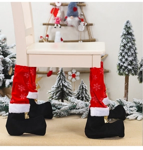 Detail of red Christmas chair leg socks with white snowflakes and black boot design
