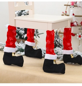 Detail of red and black Christmas elf boot chair leg covers with faux fur trim