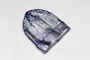 Close-up of deep blue knitted beanie with high-gloss silver sequins and elastic hem