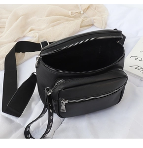 Detail der schwarzen Gürteltasche aus Leder mit mehreren Fächern und Metall-Reißverschlüssen