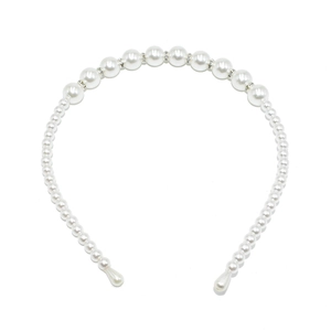 Detail of white gradient pearls and sparkling rhinestones on an elegant wedding headband