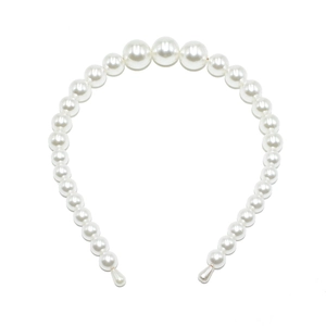 Detail of elegant white headband with gradient sized faux pearls on a minimalist base