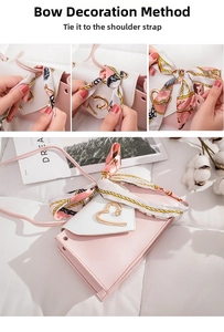 Detail of pink and white crossbody bag featuring gold heart buckle and scarf handle wrap