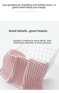 Close-up of pink cotton waffle weave washcloth with soft texture and refined edges