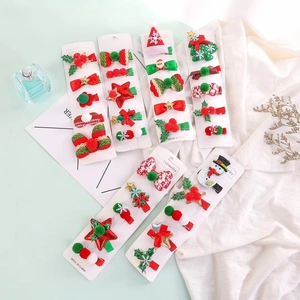 Close-up of festive Christmas reindeer hair clips set for girls on a white display card