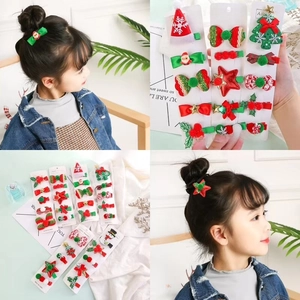 Detailed set of Christmas reindeer hair clips with Santa and tree motifs for kids