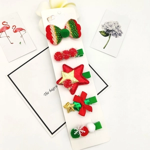 Detailed view of a 5-piece Christmas hair clip set with reindeer and holiday motifs