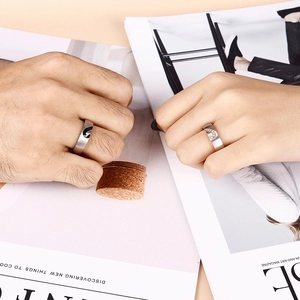 Matching stainless steel couple rings with moon-shaped inlays and brushed metal finish