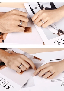 Close-up of interlocking heart couple rings with crystal inlay on stainless steel bands