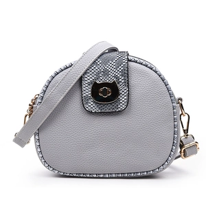Grey half-moon crossbody bag with snake skin pattern and cat-shaped metal buckle