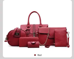 Detail view of 6-piece red handbag set featuring litchi grain faux leather and gold hardware