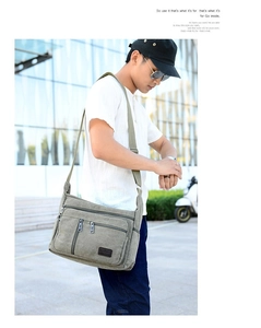 Outdoor lifestyle view of a large military green canvas messenger bag for men