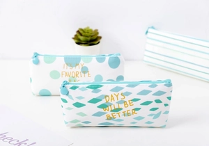 Detailed view of canvas pencil cases with gold lettering and stylish geometric patterns