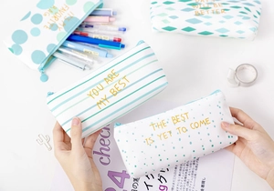 Close-up of canvas stationery pouches with gold foil patterns and creative zipper closure