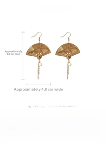 Detailed view of Chinese fan earrings with dragon relief, white pearls and long tassels
