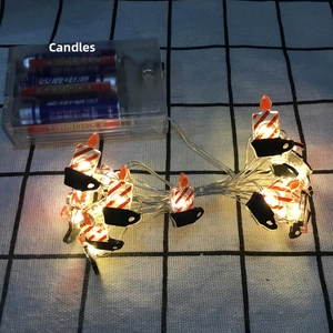 Detail of LED candle string lights with red and white stripes and clips for Christmas