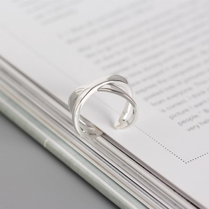 Macro shot of silver S925 sterling silver ring with minimalist double layer cross design