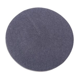 Flat lay macro view of the purple wool beret showing detailed knit texture and fabric finish