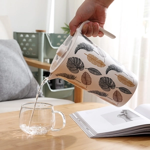 Bamboo fiber cold water pitcher with leaf pattern on a wooden table for home use