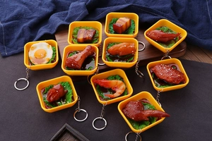 Close-up of realistic miniature Chinese food keychains with glossy textured finishes