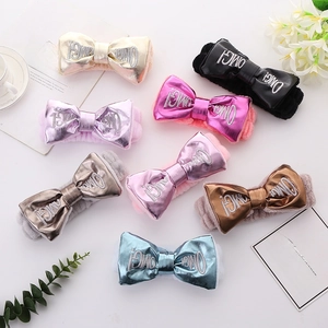 Macro detail of plush OMG! bow headbands in various colors for makeup and face washing