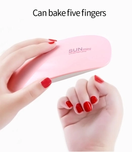 Detail showing SUNmini portable pink UV LED nail lamp curing five fingers simultaneously
