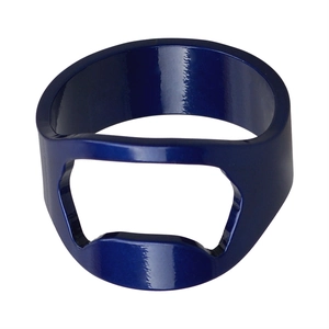 Macro detail of deep blue stainless steel ring bottle opener with a smooth metallic finish