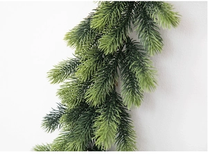 Close-up of realistic 1.8m green PE artificial pine garland for Christmas decor