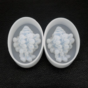 Detail of oval resin ear plugs with white shell texture and blue layered patterns