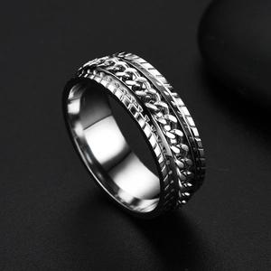 Close-up of a silver stainless steel ring featuring a detailed chain link tire tread design