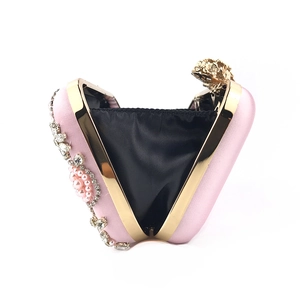 Detail of pink satin evening clutch with pearl rhinestones and gold flower clasp