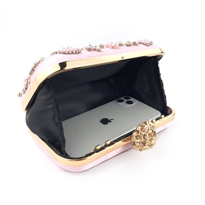 Pink satin evening clutch with pearl rhinestones showing internal space for a smartphone